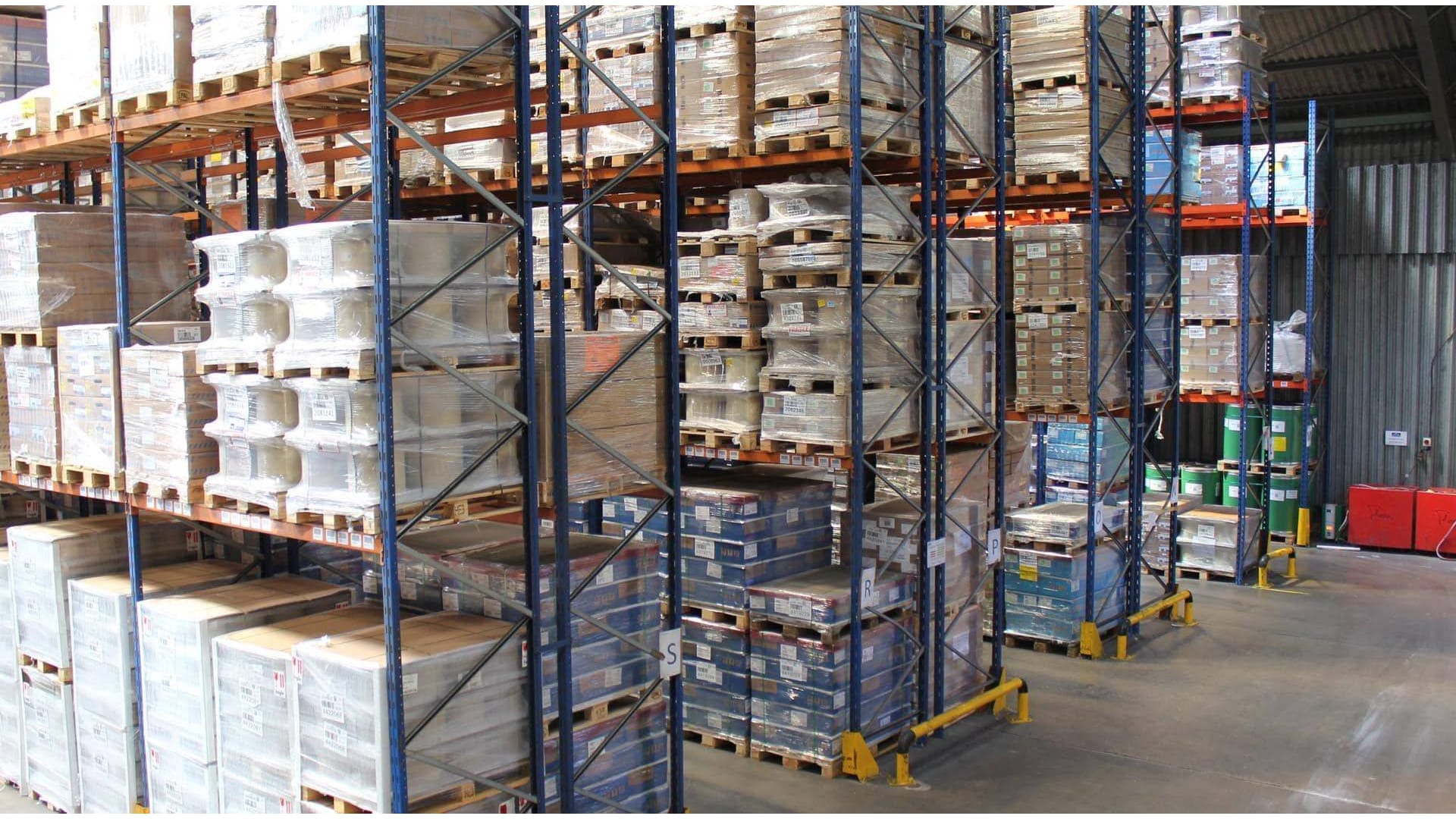 Image of warehouse shelves with neatly stacked boxes and cartons.