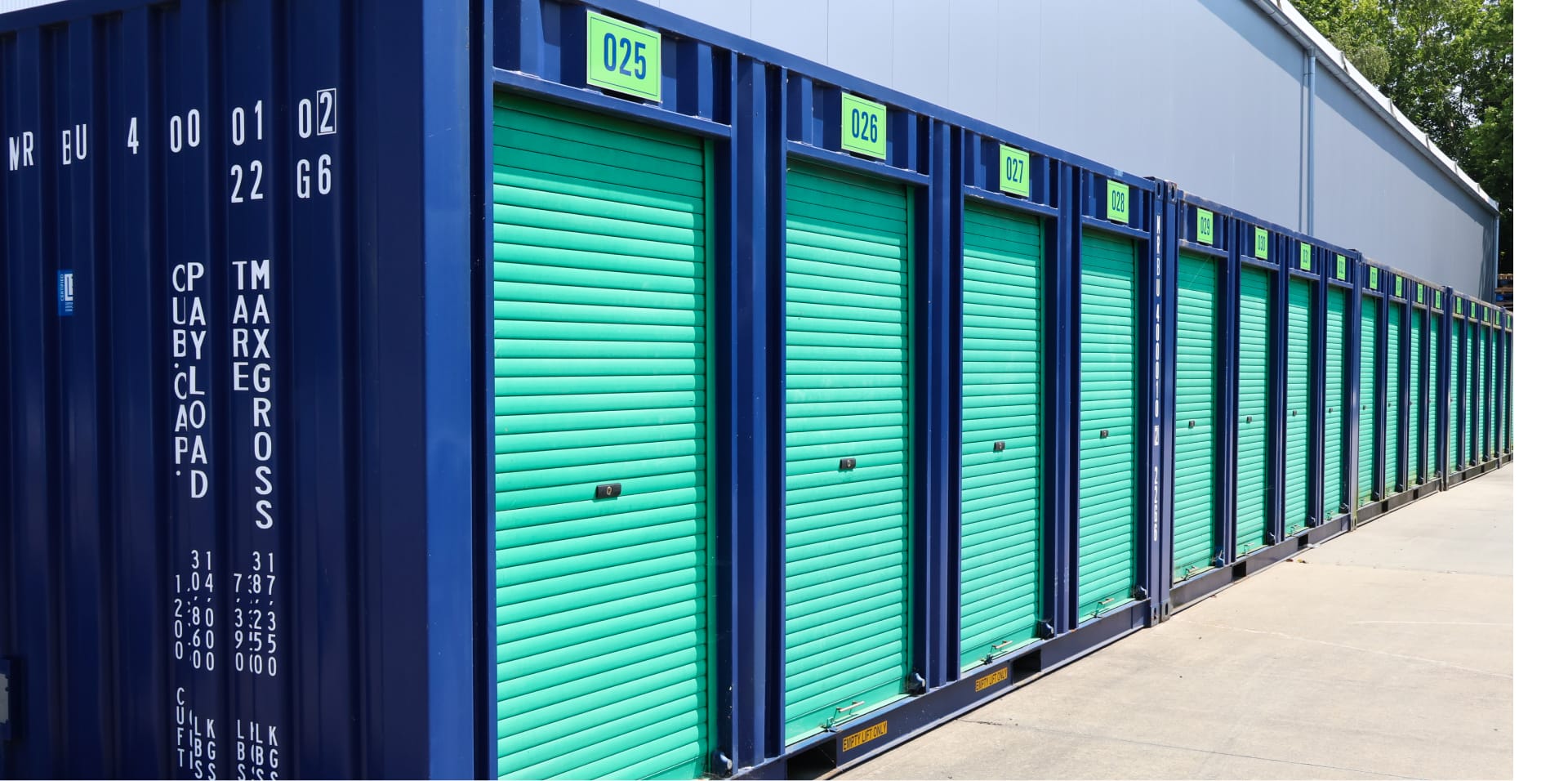 a row of dark blue containers with fluorescent green shutter doors.
