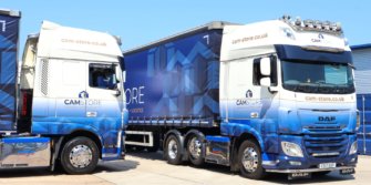 Two blue and white lorries with Cam Store logos.