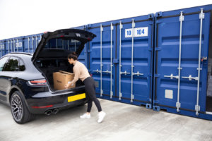 Woman unpacking Box from Car to put into self storage container